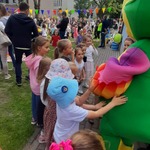 Dzieci bawią się z pluszową papugą